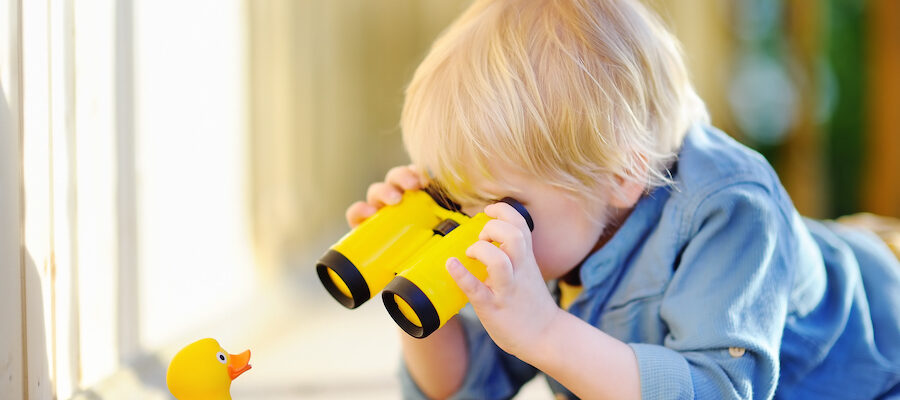 Child playing with binoculars for why don't employees change their behavior