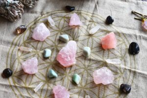 pink and Green Chakra stones in a crystal grid