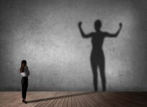 woman and her super-sized shadow for the power of positive self-talk (positive thinking)